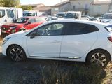 a white car parked in a lot with other cars in the background