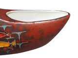 a red bowl that has a fish design on it