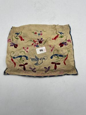 a close up of a piece of cloth with birds and flowers on it