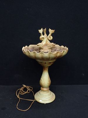a bird that is sitting on top of a fountain