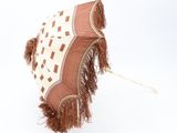 a brown and white umbrella with fringes on it