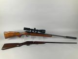 a couple of rifles sitting on top of each other
