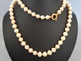 a white pearl necklace and bracelet set on a mannequin mannequin