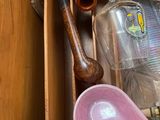 a wooden box filled with assorted items including a skateboard