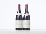two bottles of wine sitting next to each other on a table