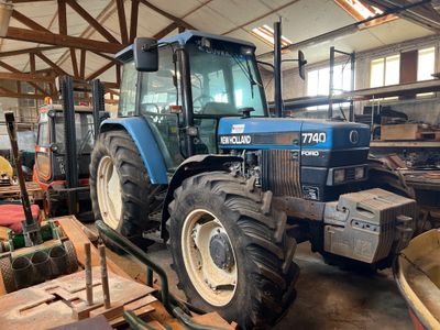 a blue tractor that is parked in a building