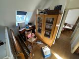 a view of a living room from the top of the stairs