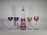 quatre verres à vin et une carafe posés sur une table