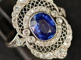 a close up of a ring with a blue stone