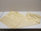 a white table with a yellow apron on it