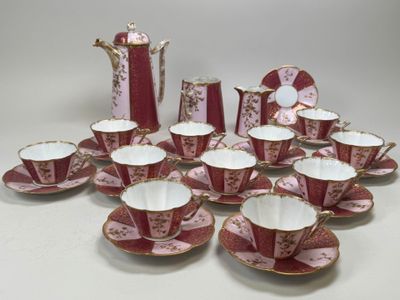 many cups and saucers that are sitting on a table