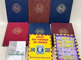 several books are sitting on a table with a white table cloth