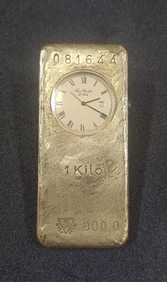 a gold bar with a clock on top of it