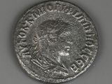 a silver coin with a man ' s head on it