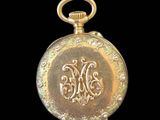 an image of a gold pocket watch on a black background