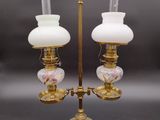 pair of antique brass and glass lamps on a stand