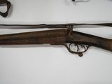 two old guns are on display on a white surface