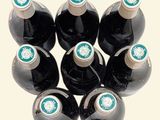 bottles of wine are arranged in a circle on a white surface