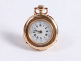 a small gold pocket watch with roman numerals on it