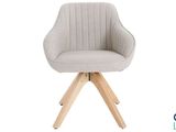 a close up of a chair with wooden legs and a white background