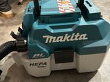 a close up of a blue and white vacuum cleaner on a floor