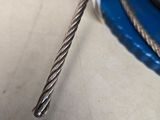 a close up of a rope with a piece of metal on top of it