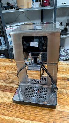 an image of a coffee machine on a wooden table