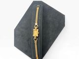 a close up of a black box with a gold zipper