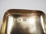 a silver plate on a table with a silver background