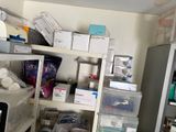 a room with a lot of clutter and boxes on the shelves