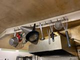 pots and pans hanging from the ceiling in a kitchen