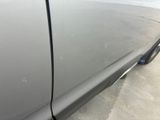 the side view of a car with a denting dent on it