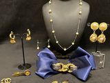 jewelry is displayed on a mannequin with a blue bow tie
