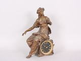a statue of a woman sitting on top of a clock