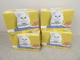 quatre boîtes de nourriture pour chat haut de gamme posées sur une table