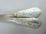 two spoons that are sitting on a table
