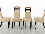 set of four dining chairs with black legs and a beige upholstered seat