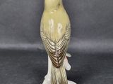 a yellow bird that is sitting on top of a table