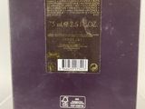 the back of a purple box with a black label on it