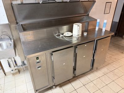 a stainless steel kitchen with a sink and a counter