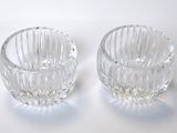 two clear glass bowls sitting on top of a white surface