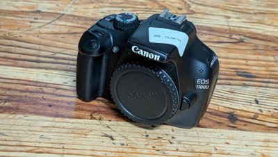 a black camera sitting on a wooden table