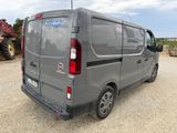 a grey van that is parked in a lot