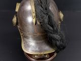 a helmet with a long black hair on top of it