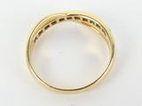 a yellow gold ring with a diamond set in the center