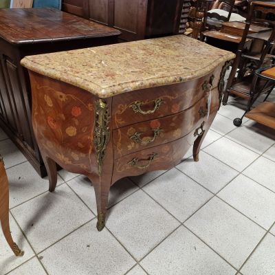 an antique chest of drawers with a marble top in a store