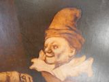 un tableau représentant un clown et un chien posés sur une table