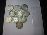 some silver coins sitting on top of a white sheet of paper