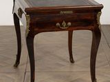 a small table with a drawer on it on a wooden floor