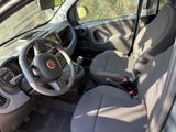 the interior of a small car with a steering wheel and dashboard